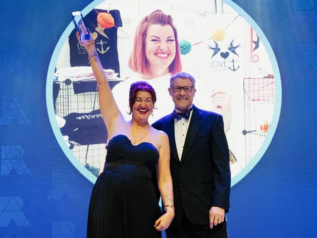 Lulu Whitmore celebrates on stage with Mark Waldron, editor in chief for National World.   Picture: Keith Woodland (270321-336)