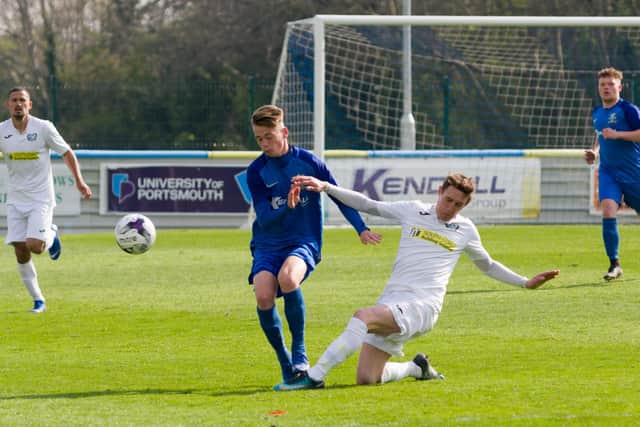 Robbie Taw (blue) has signed for Horndean from Baffins Milton Rovers. Picture: Duncan Shepherd