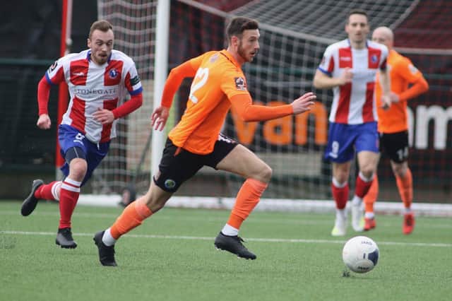 Josh Taylor on the ball for Hawks at Dorking Wanderers in their last NL South game the regular 2019/20 season. Dorking are currently top of the division and threatening legal action following the decision to null and void the sixth tier campaigns in 2020/21. Pic: Kieron Louloudis.