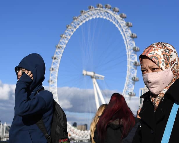 People cover their faces in London as number of coronavirus cases continue to rise in UK. Picture: DANIEL LEAL-OLIVAS/AFP via Getty Images