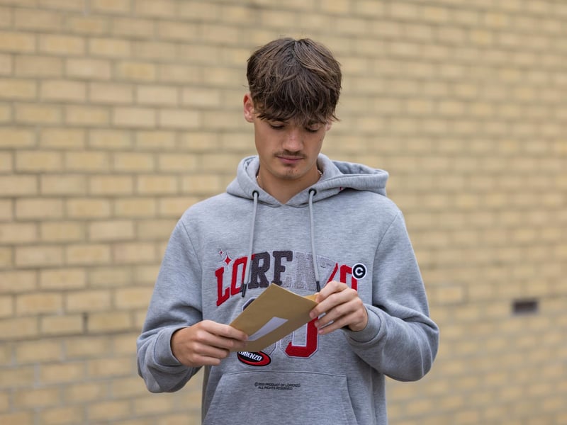 Havant Academy student Bailey Rand (16) opens the envelope containing his GCSE results. Picture: Mike Cooter (240823)