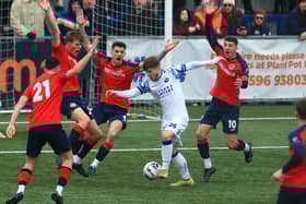Charlie Ruff is outnumbered by Hampton & Richmond opponents. Picture by Dave Haines