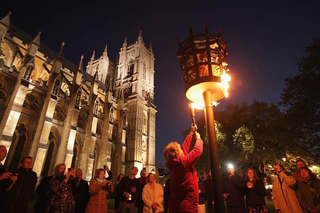 Reverend Jane Hedges, Canon of Westminster Abbey, lighting a beacon as part of Diamond Jubilee celebrations on June 4, 2012.