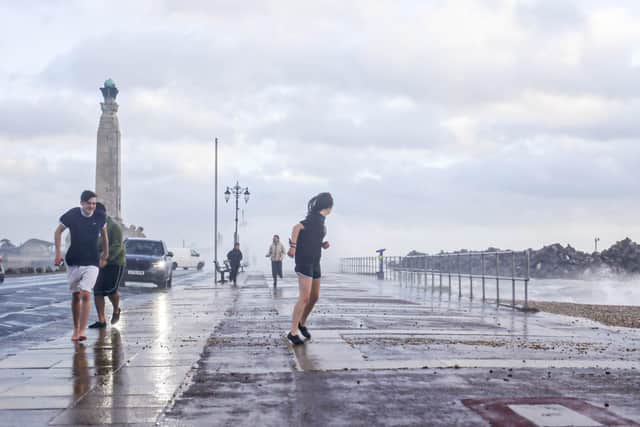 People in shorts braving the conditions on Southsea Common.