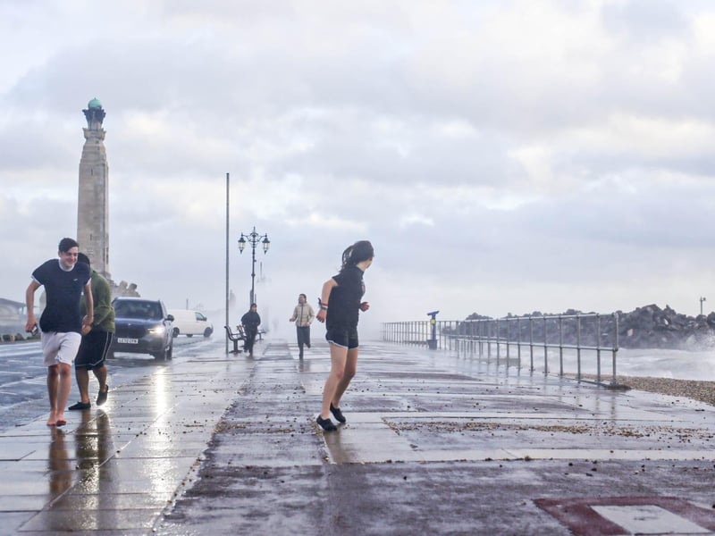 People in shorts braving the conditions on Southsea Common.