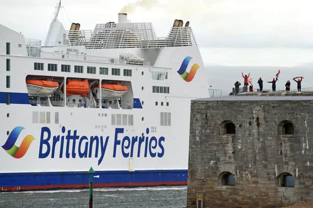 Loved ones aboard Brittany Ferries, Mont St Michel this morning were waved off by people with flags on top of the Round Tower in Old Portsmouth on Sunday morning   
Picture: Simon Czapp/Solent News & Photo Agency