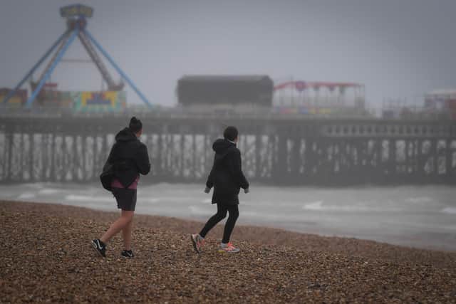 People on Southsea beach in windy weather yesterday Picture: Finnbarr Webster/Getty Images