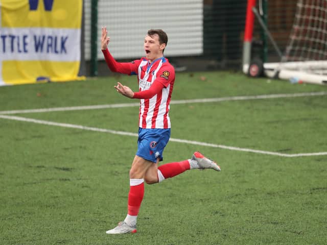 Dorking's Alfie Rutherford celebrates in front of the Hawks fans after scoring his third goal in Dorking's sensational 8-0 victory. Picture: Dave Haines