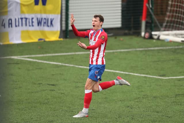 Dorking's Alfie Rutherford celebrates in front of the Hawks fans after scoring his third goal in Dorking's sensational 8-0 victory. Picture: Dave Haines