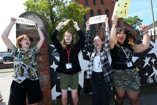 From left, Riley Lewis, 13, Kate Lambert, 15, Lee Morley, 13, and Maria Capatina, 14, invite drivers to honk in support of the mural artists. A mural is painted in a collaboration between St John's C of E Church on Forton Road, Gosport, and Gosport and Fareham Multi-Academy Trust
Picture: Chris Moorhouse (jpns 270523-16)