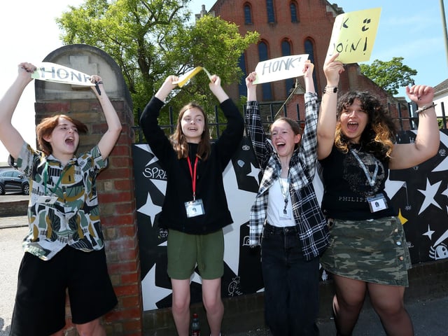 From left, Riley Lewis, 13, Kate Lambert, 15, Lee Morley, 13, and Maria Capatina, 14, invite drivers to honk in support of the mural artists. A mural is painted in a collaboration between St John's C of E Church on Forton Road, Gosport, and Gosport and Fareham Multi-Academy Trust
Picture: Chris Moorhouse (jpns 270523-16)