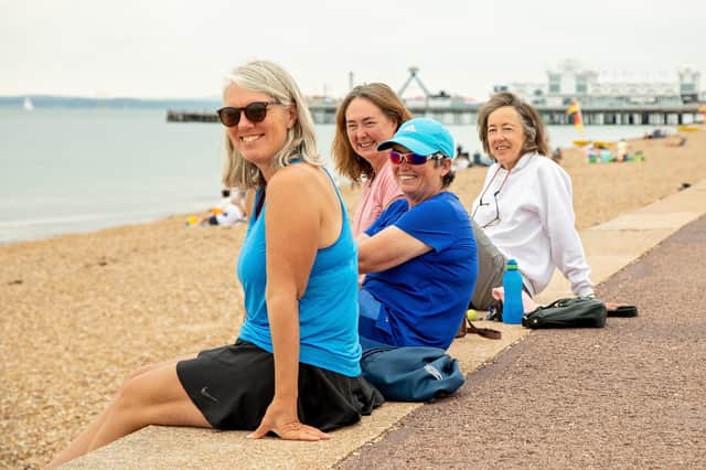 Tennis players Cressida Williams (55), Katy Bracher (56), Kate Gurl (49) and Nikki Scott (62) take a post-match rest on the seafront. Picture: Mike Cooter (150721)