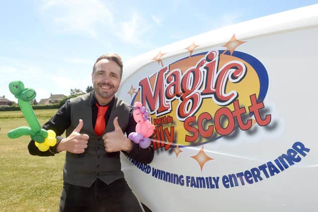 Silly Scott entertains the crowds with balloon animals and a magic show.
Picture: Sarah Standing (280622-986)
