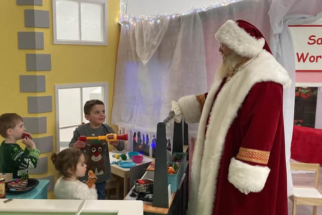 From left, James McVean, four, Rosanna Morton, two, and Eddie Morton, four, meet Father Christmas