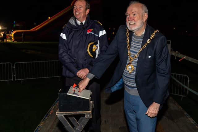 Captain John Voyce (OBE, RN) looks on while Mark Hook (Mayor of Gosport) presses the plunger to light the bonfire. Picture: Mike Cooter (281021)