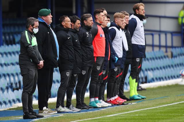 Pompey boss Danny Cowley, along with his backroom staff and substitutes, observe a period of two minutes silence ahead of Saturday's game against Burton