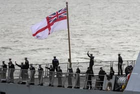 The ship's company of HMS Dragon wave to friends and family as she returns to Portsmouth Picture: Steve Parsons/PA Wire