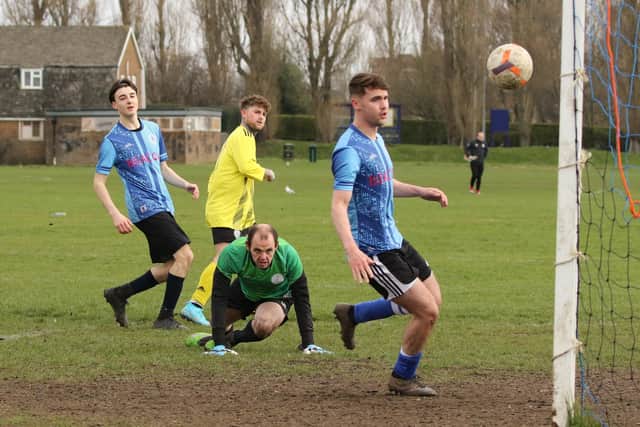 Ross Phelps (yellow) scores one of his five goals for Freehouse against King George Rovers. Picture by Kevin Shipp