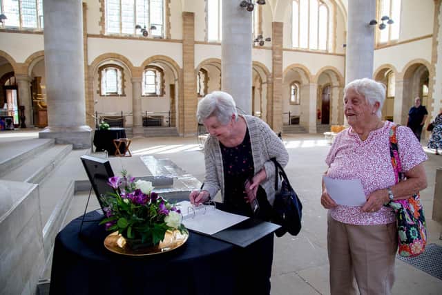 Jenny Smart and Gladys Horn sign the book of condolence for Her Majesty The Queen 
Picture: Habibur Rahman