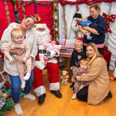 Samantha Mills with Carter Lowden (one) and Haisely Lowden (five weeks old) held by Santa (Mike Jerome), Arthur Shires (two) and Arna Shires (one) with Scarlett Turner (33), and Natasha Duquemin (35) holding Harrison (four months). Picture: Mike Cooter (261121)
