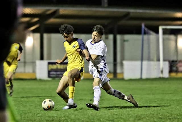 Gosport teenager Joao Ferreira, left, gets a nudge in the back from a Reading City player. Picture: Tom Phillips