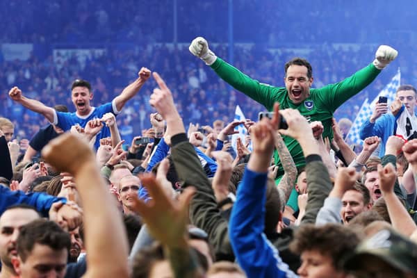 David Forde and  Enda Stevens are held aloft by Pompey fans after the Blues clinched the League Two title on the final day of the 2016-17 season. There'll be no such scenes this season, even if football returns. Picture: Joe Pepler