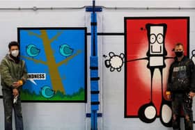 Artists My Dog Sighs (right) and Fark with the new mural.