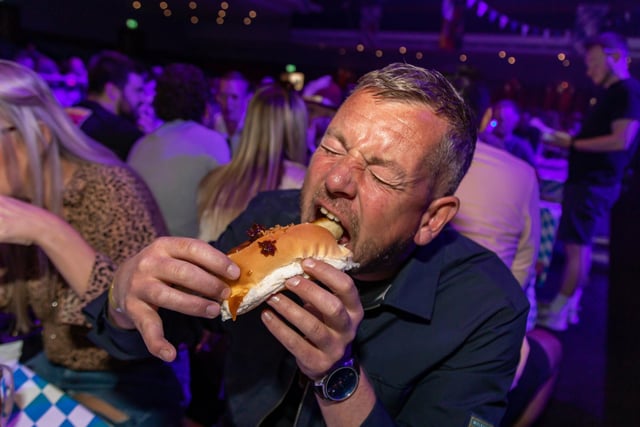 Craig Jupp battling a Bratwurst at the Oktoberfest. Picture: Mike Cooter (240922)
