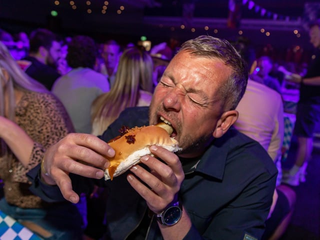 Craig Jupp battling a Bratwurst at the Oktoberfest. Picture: Mike Cooter (240922)