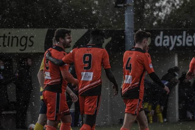 A snow flurry in April as Steve Ramsey (left) is congratulated after his goal for Portchester against Paulsgrove. Picture: Daniel Haswell.