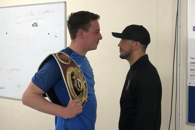 US Portsmouth defender Tom Cain, left, has the WBO Global welterweight belt over his shoulder and faces off with Mikey McKinson