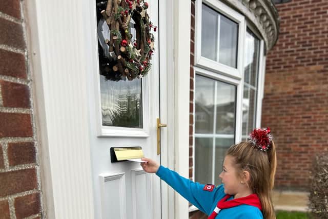 Beaver Scout delivers Christmas card.