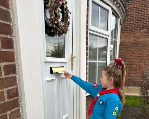 Beaver Scout delivers Christmas card.