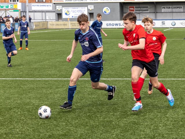 Action from the Under-14 Memorial Challenge Cup final between Pickwick Youth Pumas (all blue kit) and Horndean Youth Red. Picture: Mike Cooter