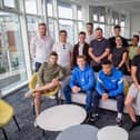 Staff with the Pompey players at their new office in Gunwharf Quays. Picture: Habibur Rahman