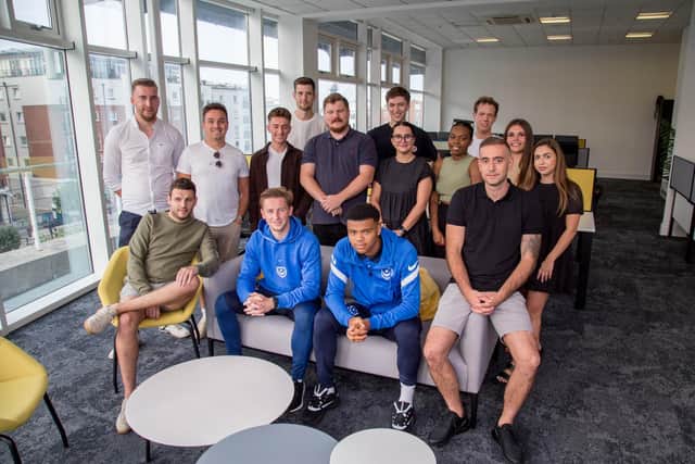 Staff with the Pompey players at their new office in Gunwharf Quays. Picture: Habibur Rahman