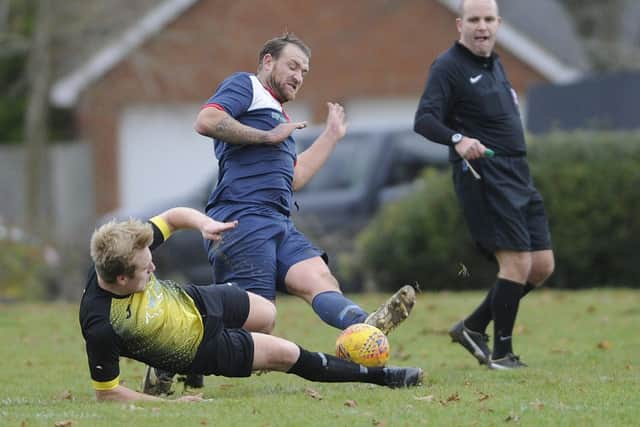Jake Warlow (blue kit) in action for Paulsgrove against Infinity last season. Picture: Ian Hargreaves