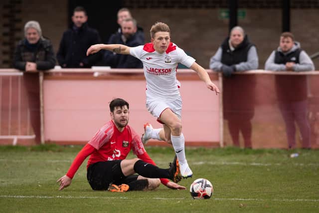 Horndean's Zack Willett (white) has now scored four successive hat-tricks against Cowes. Picture: Keith Woodland