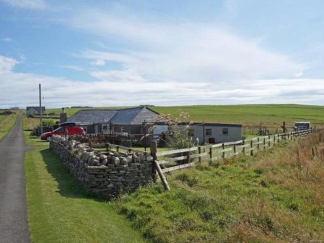 Located in Shapinsay, this bungalow is set on a five acre field, which boasts a large garden and garage. It is fitted with a stylish modern interior, with a Rayburn range kitchen. However it also offers traditional character, from features such as the beamed ceiling in the living room. 155,000 GBP.