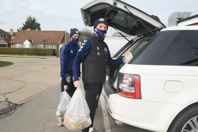 Gosport Borough FC players Pat Suraci, left, and Joe Lea loading cars with 'Feed a Family in Need' food parcels. Picture: Sarah Standing.