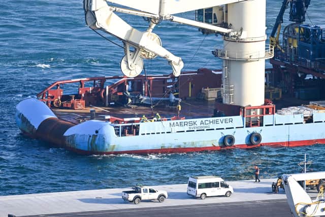 The recovered tail section of the Merlin Mk4 helicopter is bought into Portland Port, on September 18, 2024 in Portland, England. A Merlin Mk4 helicopter ditched into the sea close to HMS Queen Elizabeth while conducting night training off the Dorset coast on September 5. The pilot, Lt Rhodri Leyshon, was killed and two of the three crew from the 846 Naval Air Squadron aircraft were rescued.