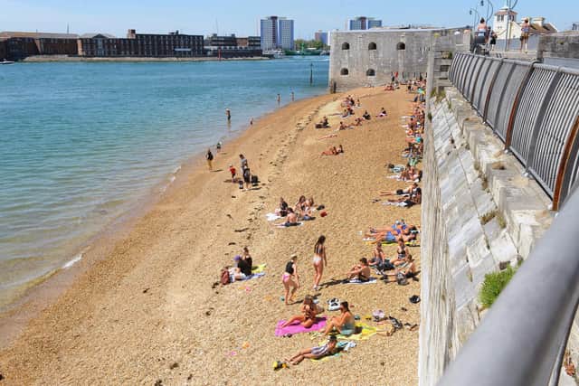 People on the beach near the Hot Walls in Old Portsmouth. Picture: Sarah Standing (210520-8798)