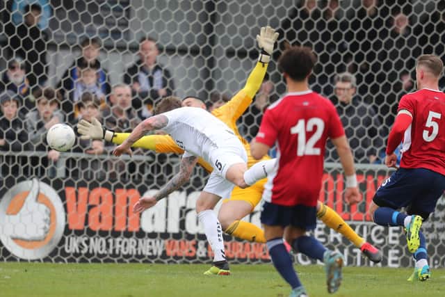 Dean Beckwith sees a header saved by Hampton keeper Dion-Curtis Henry. Dave Haines