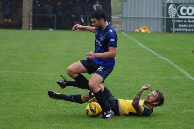Moneyfields' Jake Knight slides in to make a tackle against Clanfield. Picture: Dan (JMA Media).