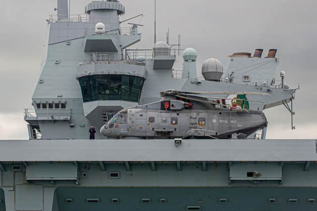 HMS Queen Elizabeth pictured with a Merlin helicopter on her fllight deck,

Picture: Habibur Rahman