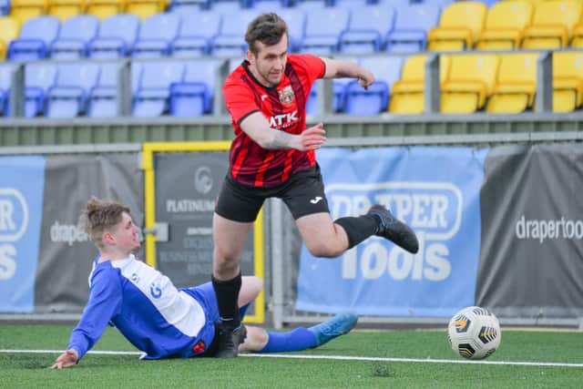 Lewis Saunders of Horndean skips past this challenge from Rowner's Bradley Pearce. Pic: Martyn White.