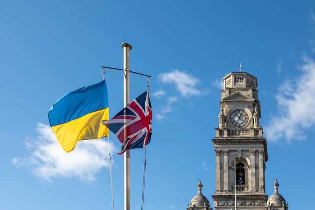 The Ukrainian flag flying alongside the Union flag In Guildhall Square, Portsmouth. Picture: Mike Cooter (25022)
