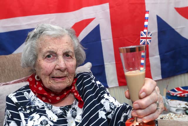 Eunice Forhead, 109, enjoys the King's coronation. Eunice is pictured toasting the King's health with, 'a little drop of Bailey's.' She told the photographer, "a little drop now and again doesn't hurt." Picture: Chris Moorhouse