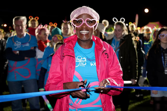 Gloria Miller, cutting the ribbon to start The Alzheimer's Society Glow Walk at Castle Field, Clarence Esplanade, Southsea, Portsmouth, which attracted hundreds of walkers.  18th March 2022
Picture by Andrew Higgins/Thousand Word Media
