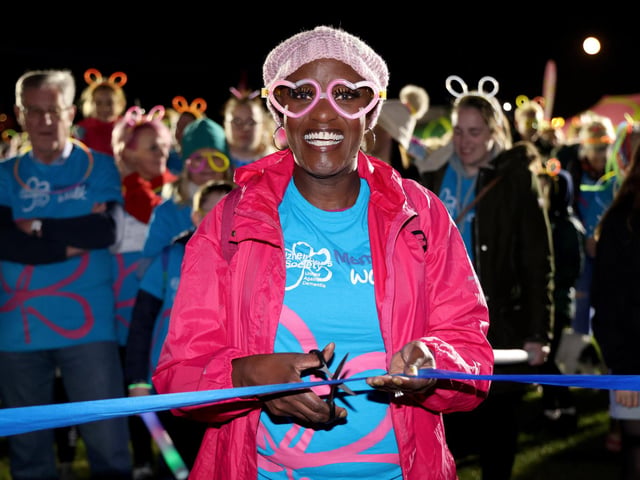 Gloria Miller, cutting the ribbon to start The Alzheimer's Society Glow Walk at Castle Field, Clarence Esplanade, Southsea, Portsmouth, which attracted hundreds of walkers. 18th March 2022
Picture by Andrew Higgins/Thousand Word Media